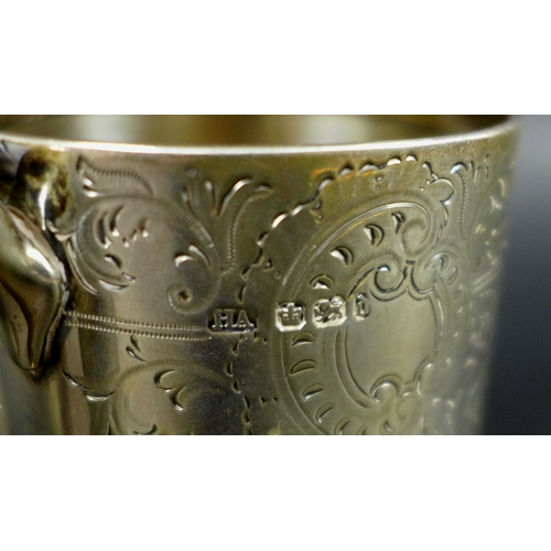 62 - A Victorian silver christening mug, the body foliate engraved around cartouche inscribed JPT 1894 fr... 