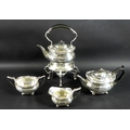 A George V four piece silver tea set comprising tea pot, milk jug, sucrier and spirit kettle on stan... 