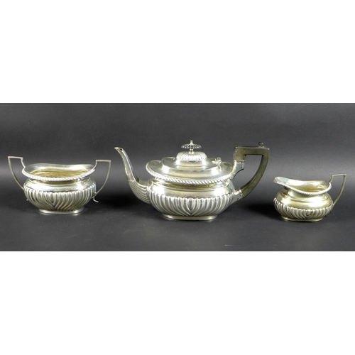 69 - An Edwardian three piece silver tea set, comprising tea pot, milk jug and sucrier, boat shaped bodie... 