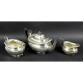 An Edwardian three piece silver tea set, comprising tea pot, milk jug and sucrier, boat shaped bodie... 