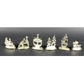 A set of six Malaysian silver name or menu holders, all depicting figures in traditional dress at va... 