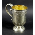 A large George VI silver christening cup, the body and foot chased and embossed with bands of traili... 