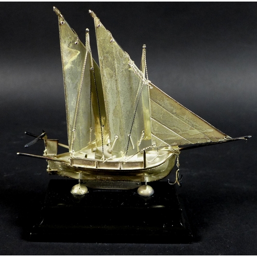 13 - A Maltese silver model of a boat or Dghajsa, hallmarked to skeg beneath the keel, on ebonised plinth... 
