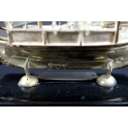 13 - A Maltese silver model of a boat or Dghajsa, hallmarked to skeg beneath the keel, on ebonised plinth... 