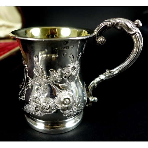 59 - A Victorian silver christening set, comprising cup, knife, fork and spoon, all foliate engraved, the... 