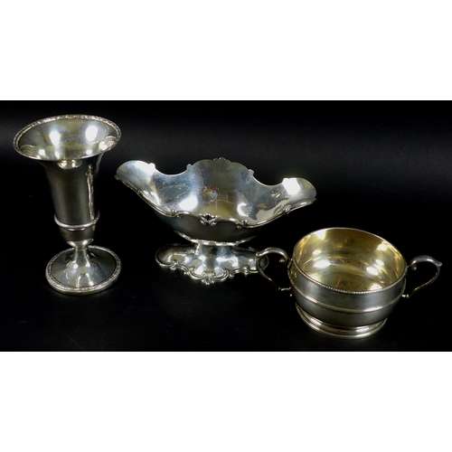 49 - A group of Edwardian and later silver, comprising a Rococo style sauce boat on stand, London 1905, H... 