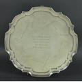 A silver salver with pie crust rim, the body with central inscription engraved 'To Captain and Mrs B... 