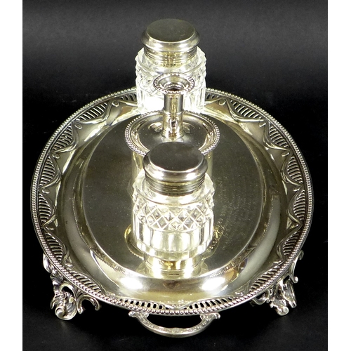 73 - A George III and Victorian silver desk stand of oval twin handled form, with swag decoration within ... 