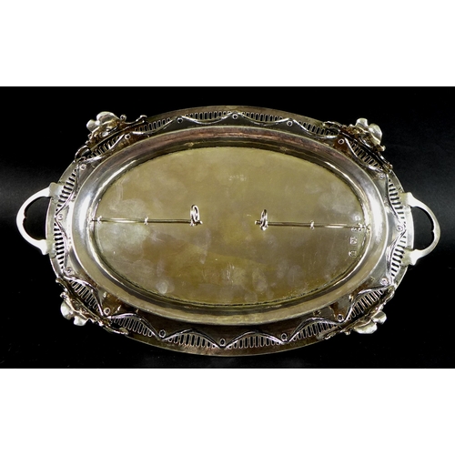 73 - A George III and Victorian silver desk stand of oval twin handled form, with swag decoration within ... 