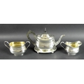 A George V silver tea set, comprising teapot, milk jug and sucrier, all with matching lobed horizont... 