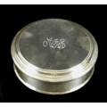An Elizabeth II silver box by Asprey & Garrard, of circular form with stepped rim to lid, the lid en... 