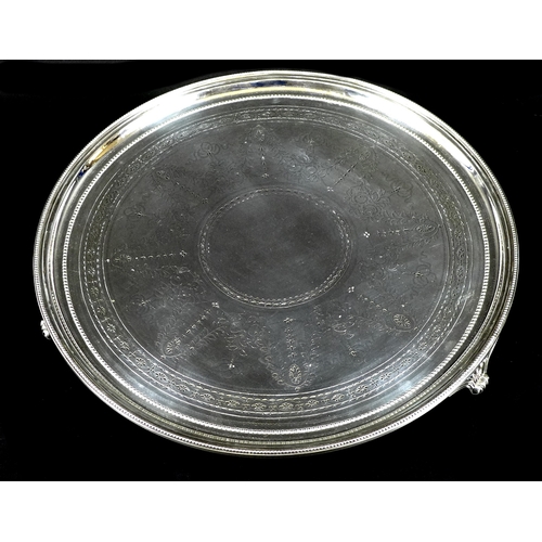 75 - A large Victorian silver salver, the body engraved with foliate swags and drapery, beaded rim and th... 