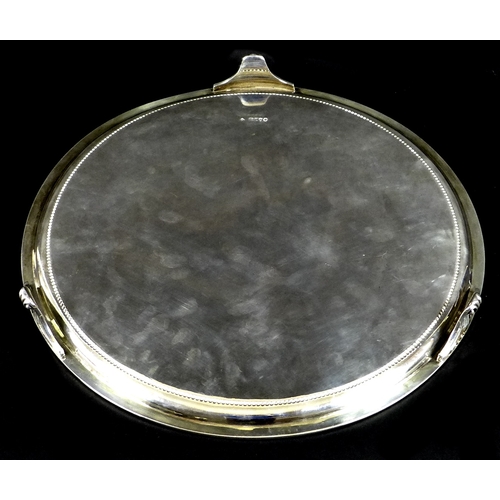 75 - A large Victorian silver salver, the body engraved with foliate swags and drapery, beaded rim and th... 