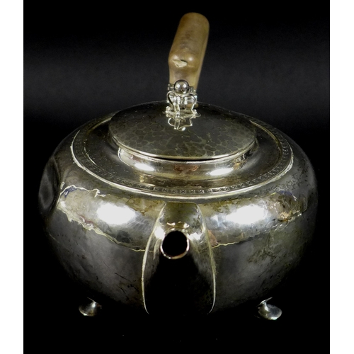 37 - An Arts & Crafts silver teapot, of squat ovoid form with shaped handle and raised on three feet, Alb... 