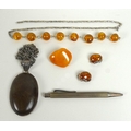 A collection of silver and amber jewellery, comprising a vintage butterscotch coloured brooch, a dar... 