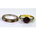 A 9ct white gold ring set with central large garnet flanked by two diamonds, approx 0.15cts total di... 
