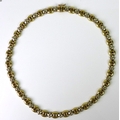 A 9ct gold necklace formed of yellow gold ovals interspersed with white gold spacers, clasp marked 3... 