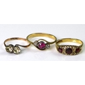 A group of three rings, one a late 19th or early 20th century three stone ring, central pink stone, ... 