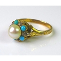 A 9ct gold ring set with turquoises and diamonds around a central pearl of approximately 6.5mm diame... 