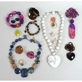 A collection of Lola Rose carved semi-precious jewellery, including a purple dyed fossil jasper neck... 
