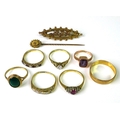 A group of five 9ct gold rings, including a ruby and diamond dress ring, size N, and a gentleman's w... 