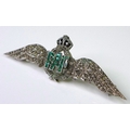 An 18ct white gold RAF dress brooch set with diamonds and emeralds, two diamond encrusted wings flan... 