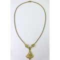 A 14ct gold Edwardian style pendant set with seed pearls and peridots, pierced chandelier form, mark... 