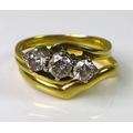 An 18ct gold three stone diamond ring, the central diamond of approx 0.25cts flanked by two diamonds... 