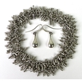 A silver fringe form necklace, 39.7g, together with a pair of white metal drop earrings by Pilgrim. ... 