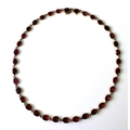 An 18th/19th century rose gold and red stone riviere necklace, the stones possibly garnets, oval cut... 
