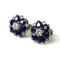 A pair of diamond and sapphire earrings of flowerhead design, each central diamond approx 0.1ct and ... 