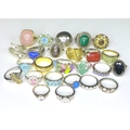 A collection of silver rings, many set with gemstones including lapis lazuli, rose quartz, malachite... 