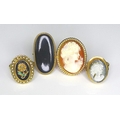 A group of 9ct gold rings of Victorian design, comprising two cameo rings, one set against a carneli... 