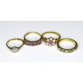 A group of four Victorian/Edwardian 9ct gold rings, comprising a flowerhead ring set with six opals ... 