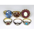 A group of six 9ct gold and silver rings, comprising a 9ct gold dress ring in the form of a flowerhe... 