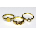 A group of three 18ct gold rings, comprising a ring set with rubies and diamond chips in a scalloped... 