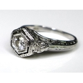 An 18ct white gold and diamond Art Deco style solitaire ring, the 0.25ct diamond within a hexagonal ... 