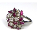 A diamond and ruby dress ring of asymmetrical cluster form, set in white gold or platinum, composed ... 