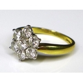 An 18ct gold and diamond flowerhead ring, the seven diamonds each of approximately 0.2ct, total diam... 