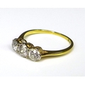 An 18ct gold and diamond three stone ring, the central diamond of 0.3ct and the two flanking it each... 