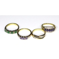 A group of 9ct gold rings, comprising an example set with princess cut emeralds and brilliant cut di... 