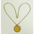 A George V gold half sovereign, 1911, in 9ct gold pendant mount, on 9ct gold chain, 11.8g total.