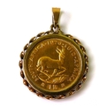 A South African gold 1 Rand coin, 1976, in 9ct gold pendant mount, 5.7g total.