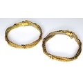 A pair of 9ct gold bracelets of woven banded form, each approximately 6.5cm diameter, 51g total. (2)