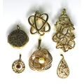 A group of 9ct gold pendants, including one of swirling design set with a pearl, a foliate engraved ... 