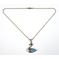 A 14k gold pendant and necklace, in the form of a swan with turquoise body and diamond chip eye, 3 b... 