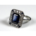 An Art Deco style sapphire and diamond dress ring, with central emerald cut stone, 9 by 7 by 4.5mm, ... 