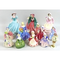 A collection of Coalport, Royal Worcester and Royal Doulton figurines, comprising Coalport Ladies of... 