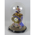A late 19th century porcelain figural mantel clock in glass dome, with blue ground gilt highlighted ... 