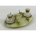 An Victorian onyx desk stand, with two glass inkwells, brass carry handle and two pen rests, raised ... 